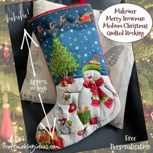 May include: A festive Christmas stocking with a snowman, Christmas tree, and presents on a white base. The upper section is blue with a reindeer and sleigh design. The stocking is approx. 48 cm high and features the text "Makower Merry Snowman Medium Christmas Quilted Stocking."
