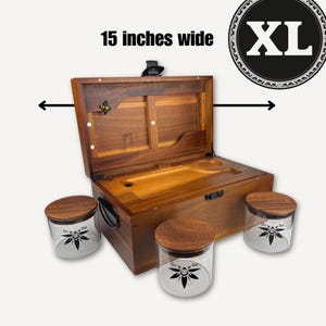 May include: A brown wooden storage box measuring 38.1 cm wide with an open lid, a black latch, and a small bee emblem inside. Three clear glass jars with matching wooden lids are placed in front, each featuring a black bee graphic and the text Bzz Box.