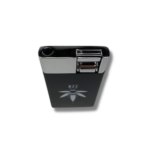 May include: Black lighter with a silver top and a bee logo that says "BZZ" on the front.