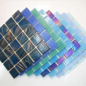May include: A variety pack of blue and green mosaic tiles. The tiles are small, square, and have a glossy finish.