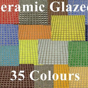 May include: A collection of 35 ceramic glazed tiles in various colours. The tiles are arranged in a grid pattern and are all the same size. The tiles are ideal for use in a variety of home decor projects.