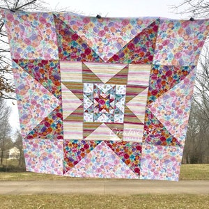VariLovable Star quilt top hanging from clothesline.