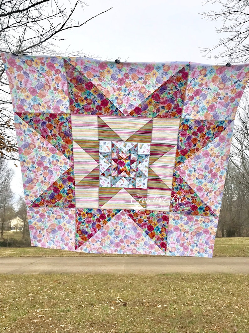 VariLovable Star quilt top hanging from clothesline.