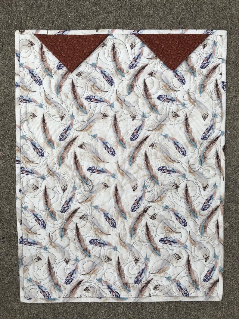 Back of quilt showing hanging method and feather focus fabric.