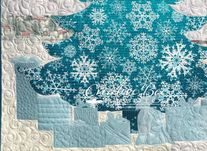 Close up of bottom of quilt, showing use of both sides of snowflake focus fabric.