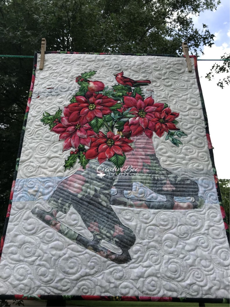 Noelle quilt hanging from clothesline.