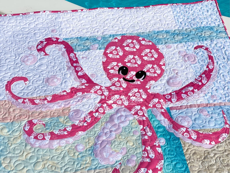 Baby octopus applique quilt shown at poolside.