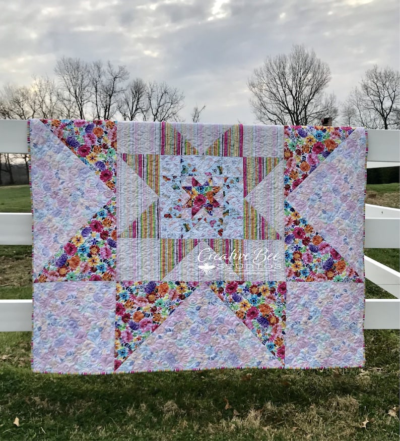 Image of quilt on fence at dawn.