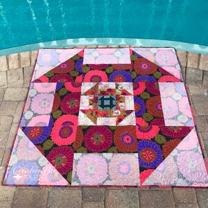 Dash About quilt photographed with pool reflections.