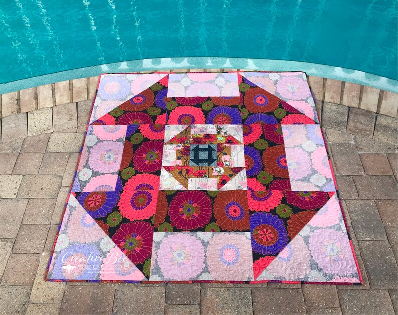 Dash About quilt photographed with pool reflections.