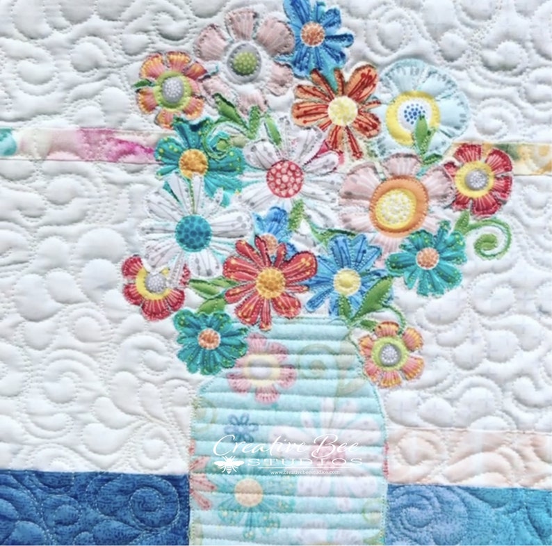 Close up of broderie perse bouquet quilt.