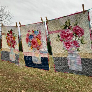 Three quilts made with the Grace quilt pattern and different focus fabrics.