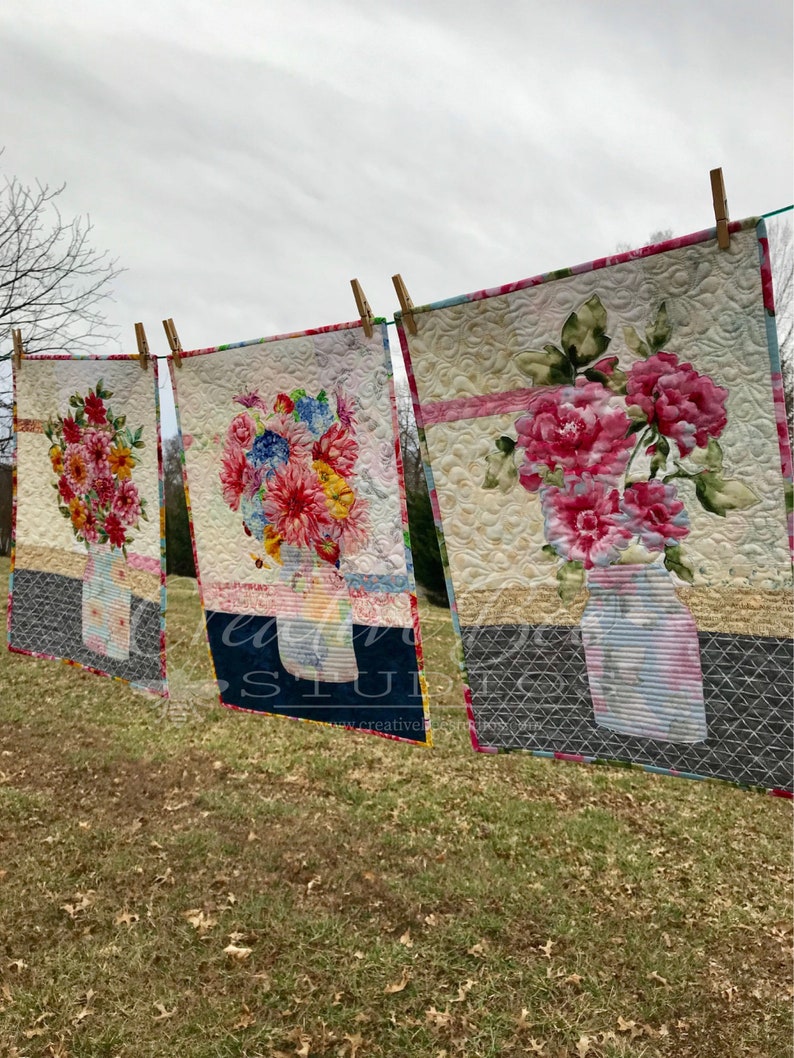 Three quilts made with the Grace quilt pattern and different focus fabrics.