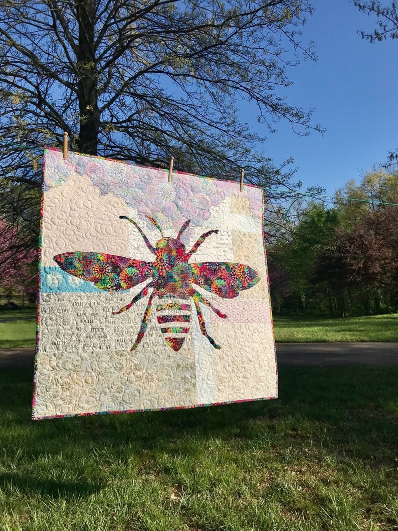 Image of bee quilt hanging on clothesline.