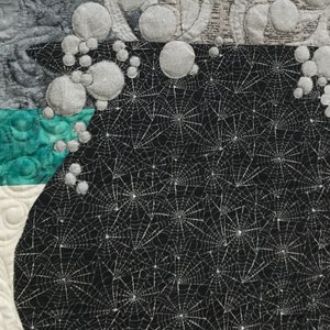 Close up view of steam and bubbles coming out of cauldron quilt.