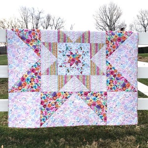 VariLovable Star Quilt hanging on white fence.