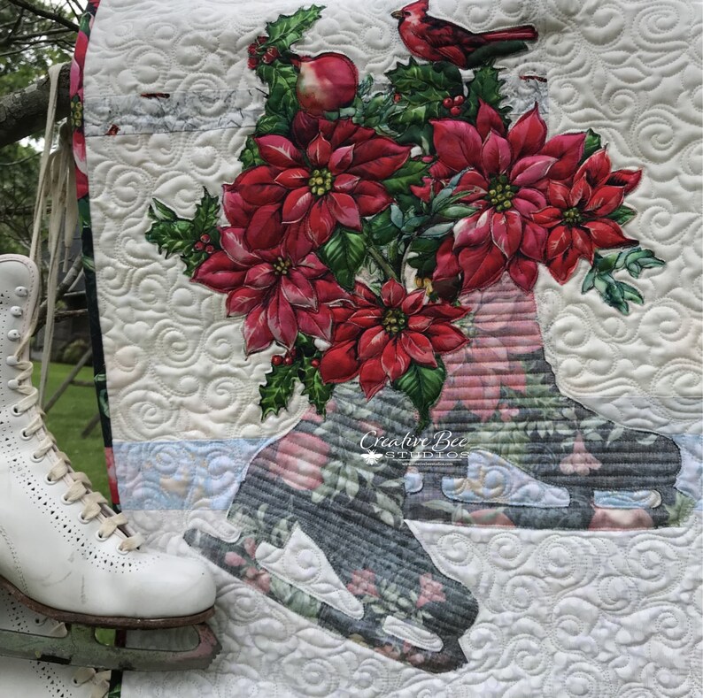 Noelle poinsettia bouquet quilt shown with ice skates.