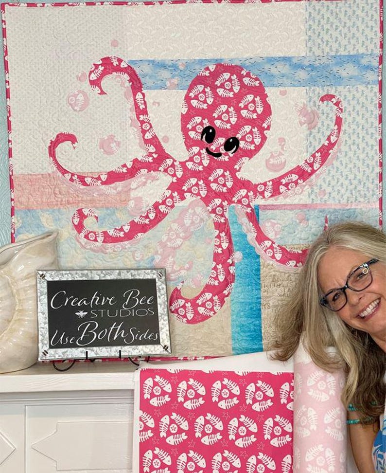 Octopus quilt pattern shown made with both sides of Fishbone Dance pink fabric designed by Karla Kiefner.