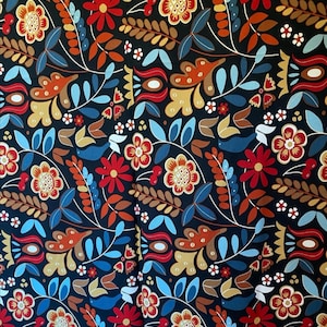May include: A fabric with a repeating floral pattern in red, orange, yellow, and blue on a black background. The design includes stylized flowers, leaves, and other botanical elements, creating a vibrant and detailed textile.
