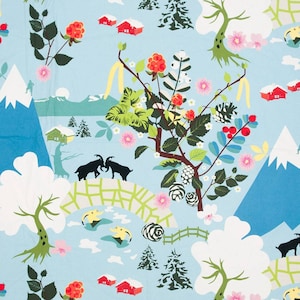 May include: A blue and white patterned fabric with a repeating design of mountains, trees, berries, and goats. The fabric has a light blue background with white clouds and a green and white brick bridge.