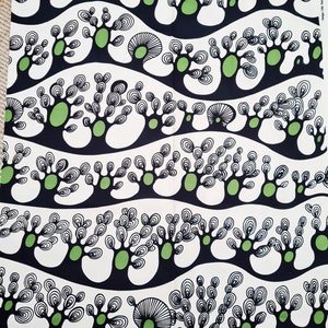 May include: Black and white fabric with a repeating pattern of stylized green trees on a white background. The trees are outlined in black and have a series of concentric circles within them.