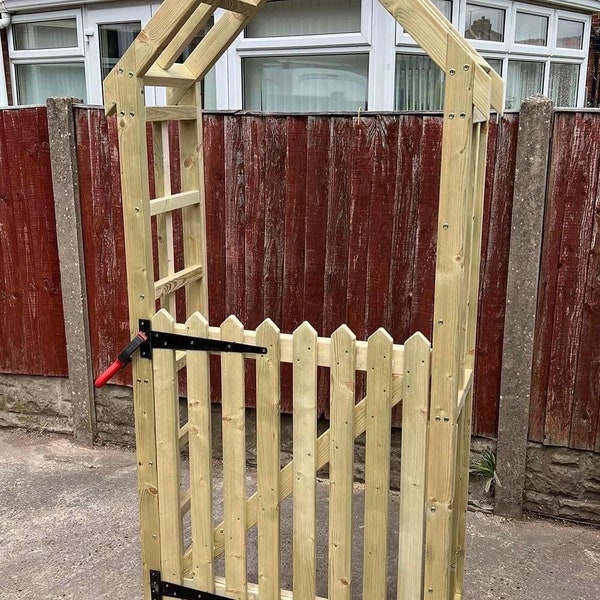 Garden arch with a gate. Garden arbour with a gate. Dog barrier.