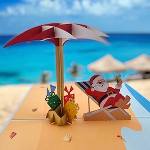 Weihnachtsmann am Strand Pop Up Karte