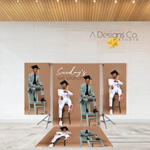 May include: A studio photograph showing three people in graduation attire, seated on chairs. The backdrop reads "Sunday's we brunch." One person wears a light green suit, while the others wear white suits. The studio's logo is visible.