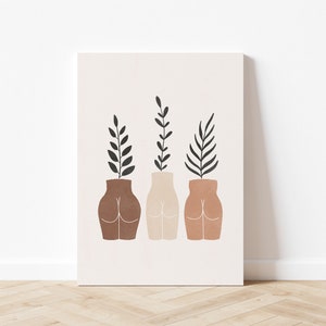 May include: Three abstract ceramic vases in brown, beige, and terracotta with leafy green plants growing from the top. The vases are shaped like human figures.