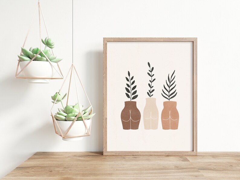 May include: A framed print with a minimalist design featuring three stylized vases with plants. The vases are different shades of brown and the plants are black.