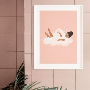May include: A framed illustration of a person relaxing in a bubble bath with a glass of wine. The person is wearing a cucumber face mask and is surrounded by bubbles. The background is a light pink color.
