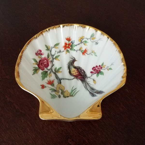 Limoges clamshell-shaped porcelain trinket dish with the image of a peacock or bird of paradise and gold accents