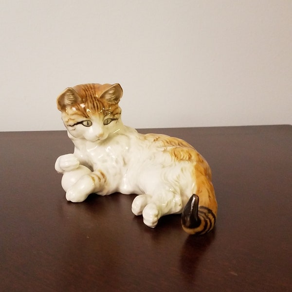 Hutschenreuther tabby cat lying down while holding a ball Hand-painted porcelain figurine Kunstabteilung made in Germany