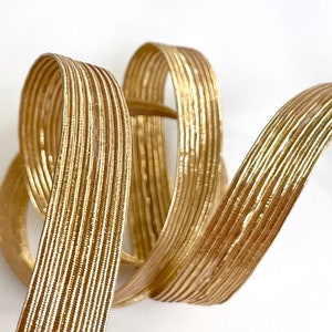 Flat elastic in metallic gold Lurex, 20mm wide, sold by the meter in multiples of 1 meter