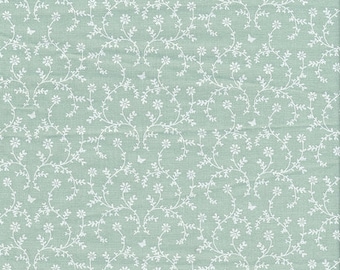 PVC-coated cotton oilcloth with a floral pattern of small flower garlands on a soft green background, sold in multiples of 10cm (142cm wide)