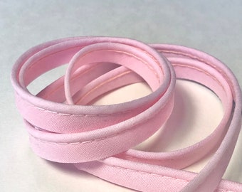 Plain baby pink piping, protruding 2mm Ø and 10mm wide, sold by the meter