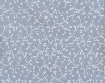 Lavender blue cotton oilcloth printed with a floral garland for tablecloths, sold in multiples of 10cm