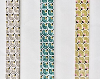 Bias binding with a stylish fan print in grey, taupe, blue-green and gold, pre-folded with 2 folds, 27mm wide, sold in multiples of 1 meter