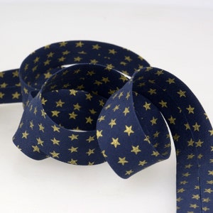 Cotton bias binding with small gold details on navy blue, folded 2cm wide with 2 pleats, sold by the meter