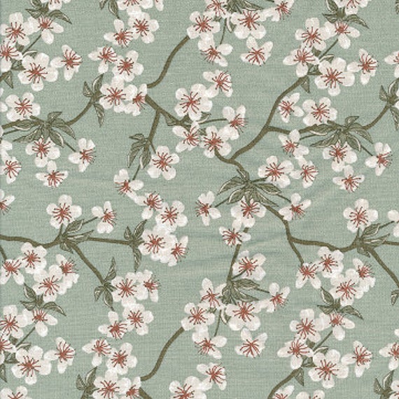 Toile cirée coton imprimé japonais fleurs de pommier vert céladon, enduit finition satiné, vendu a la coupe par multiples de 10cm