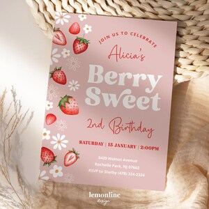 May include: Pink birthday invitation with a strawberry and flower border. The text reads "Join us to celebrate Alicia's Berry Sweet 2nd Birthday. Saturday | 15 January | 2:00PM. 3429 Walnut Avenue Rochelle Park, NJ 07662. RSVP to Shelby (478) 324-2324. lemonline design"