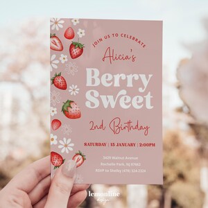 May include: Pink birthday invitation with a watercolor illustration of strawberries and white flowers. The text reads "Join us to celebrate Alicia's Berry Sweet 2nd Birthday. Saturday | 15 January | 2:00PM. 3429 Walnut Avenue Rochelle Park, NJ 07662. RSVP to Shelby (478) 324-2324. lemonline design"