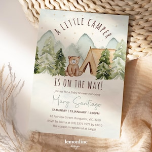 May include: A baby shower invitation with a watercolor illustration of a brown bear sitting in front of a tent in a forest. The text reads "A Little Camper Is On The Way!" and includes the name "Mary Santiago", the date "Saturday | 15 January | 2:00PM", the address "82 Fairview Street, Bungador, VIC, 3260", and RSVP information.