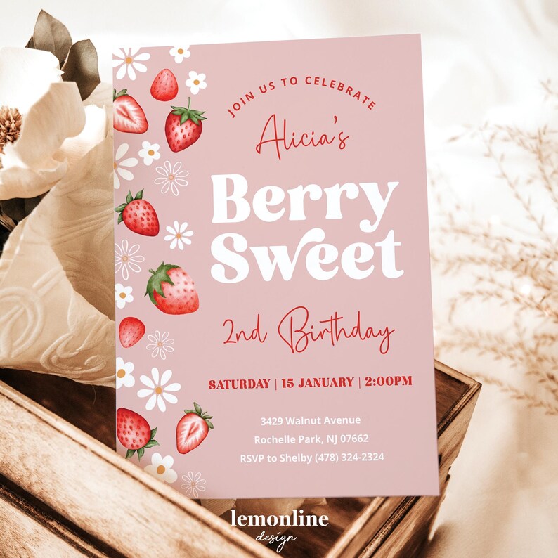 May include: Pink invitation card with a strawberry and flower design. The text reads "Join us to celebrate Alicia's Berry Sweet 2nd Birthday. Saturday, 15 January, 2:00 PM. 3429 Walnut Avenue, Rochelle Park, NJ 07662. RSVP to Shelby (478) 324-2324. lemonline design."