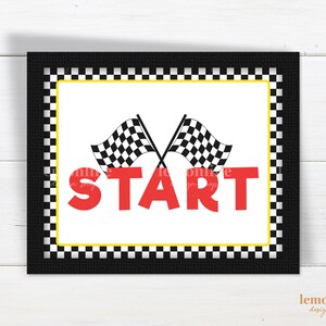 May include: A black and white checkered border surrounds a white sign with the word "START" in red letters. Two black and white checkered flags are crossed behind the word "START".