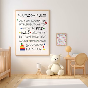 May include: A framed print with the words "PLAYROOM RULES" and other phrases like "USE YOUR IMAGINATION" and "HAVE FUN!" in black text. The print is decorated with colourful block illustrations. A small framed print with colourful letters is also visible.