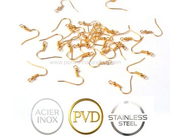 May include: A collection of gold-colored earring hooks scattered on a white surface. The hooks have a curved design with a small ball and a loop at the end. The image also includes text and logos for stainless steel and PVD.