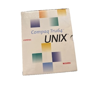 May include: A Compaq Tru64 UNIX software box. The cover is white with a grid of colorful squares in orange, green, yellow, blue, and purple. The text "Compaq Tru64 UNIX" is printed in blue and black.