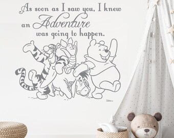 May include: A Winnie the Pooh themed wall decal featuring Winnie the Pooh, Piglet, Tigger, and Eeyore. The decal includes the text "As soon as I saw you, I knew an Adventure was going to happen."