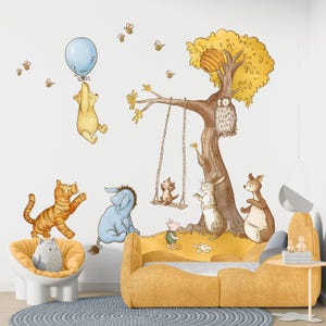 May include: A Winnie the Pooh themed nursery wall decal set featuring Winnie the Pooh, Tigger, Piglet, Eeyore, and Owl. The decals are on a white wall with a yellow couch and a blue rug.
